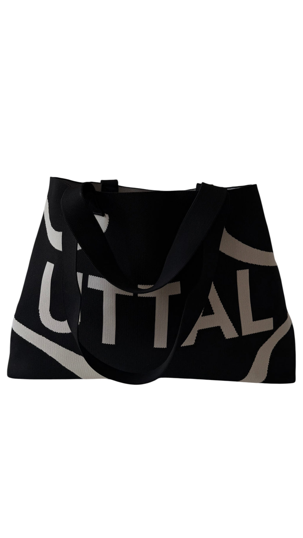 Close-up of black UTTAL tote bag showcasing premium jacquard knit texture, stitching and craftsmanship