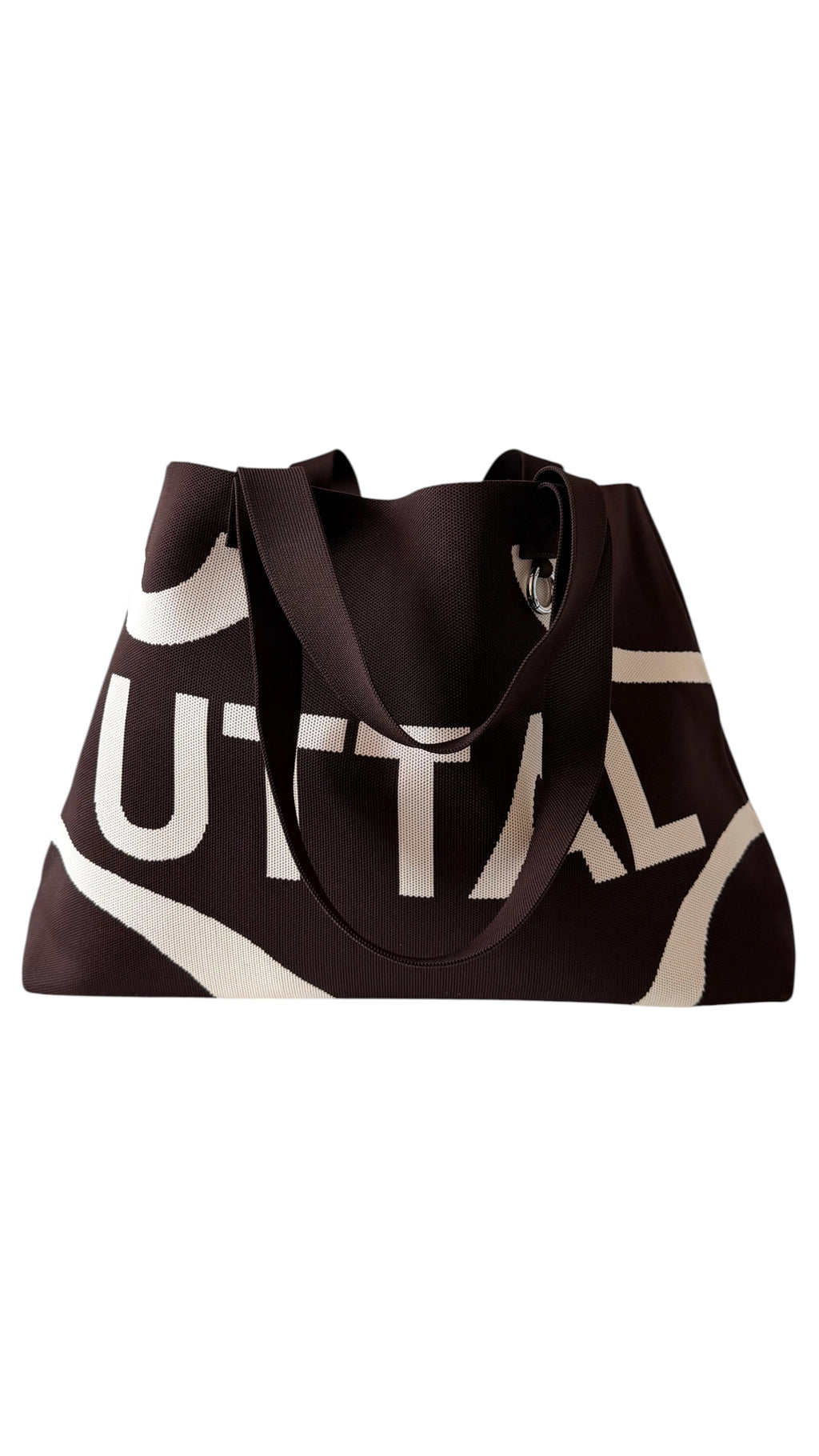 Chocolate brown UTTAL jacquard knit tote bag shown from an angled view with structured design, durable shoulder straps and premium woven fabric on a white background